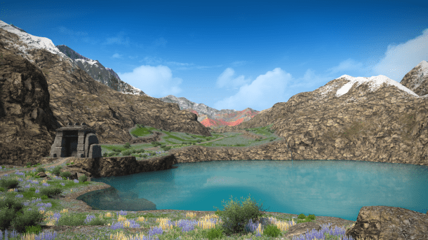 Lake of water with colorful mountains behind it.